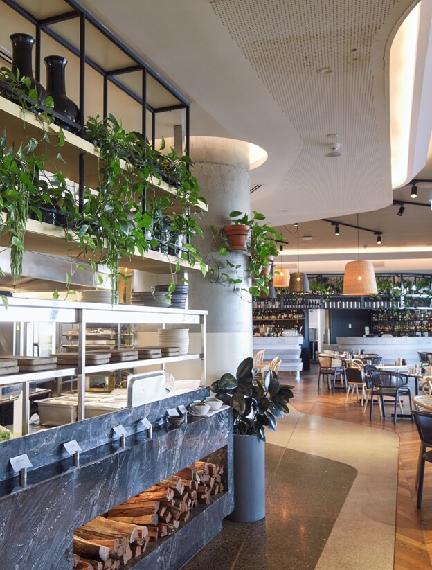 The bar and restaurant of W Hotel Brisbane, featuring trailing pothos and a stylised floor plant.
