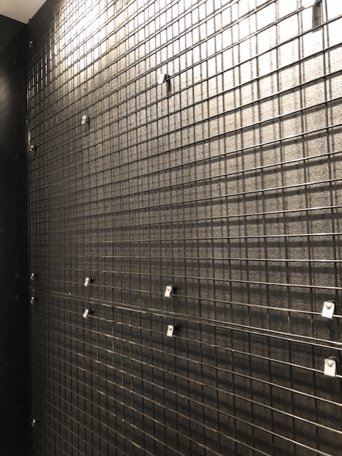 Black powder coated weld mesh fixed with mesh lock screws.